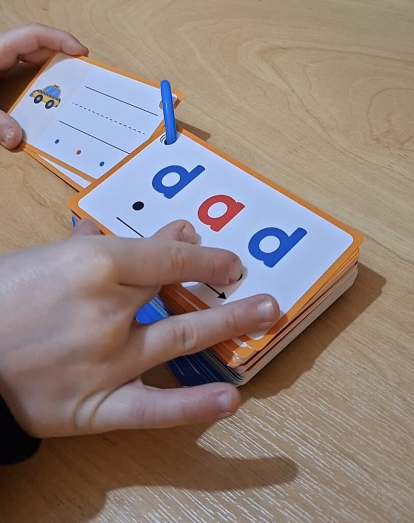 Child sounding out d-a-d